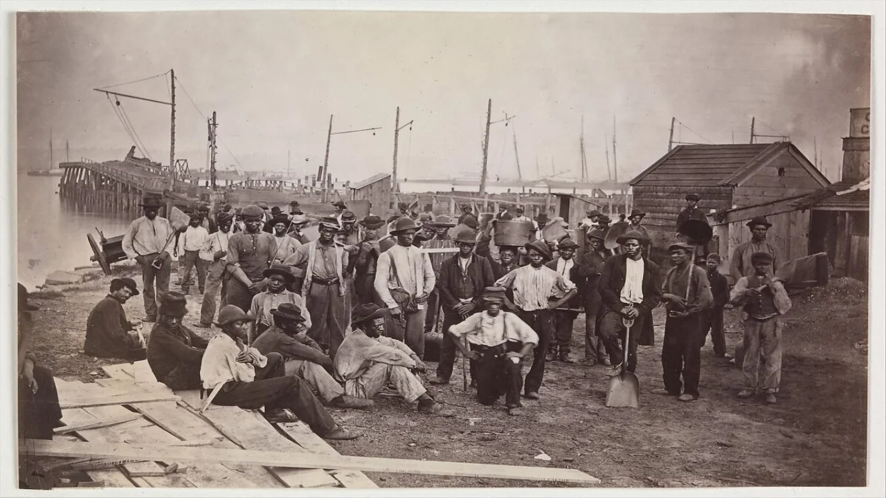 This extraordinary view shows a group of emancipated slaves who worked as paid laborers for the army along the immense set of wharves at Alexandria, Virginia.