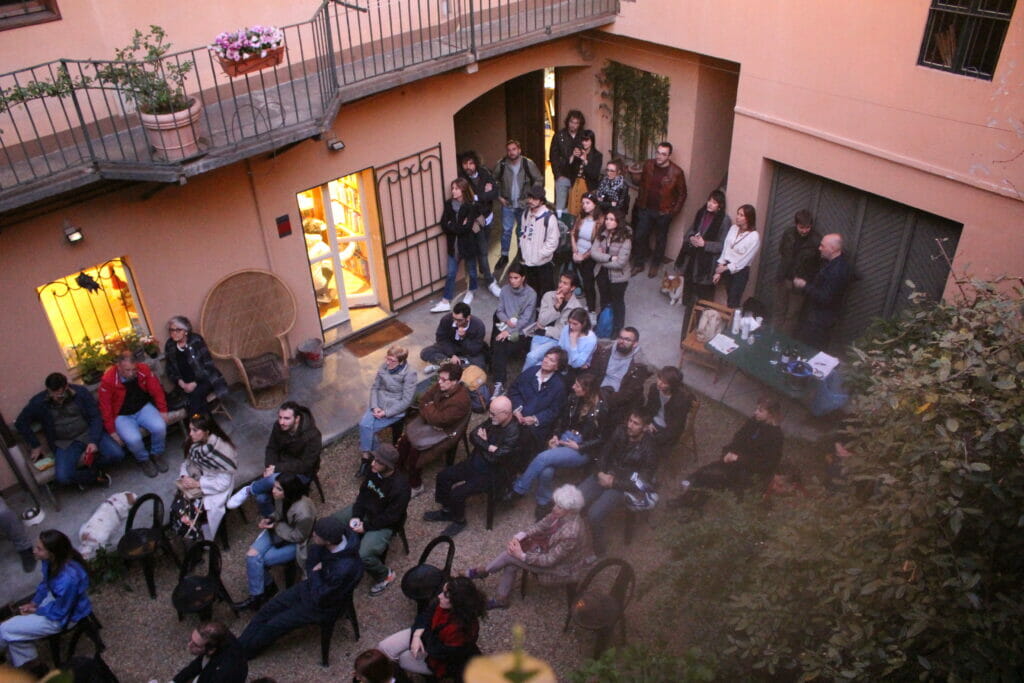 A courtyard pached with people attending a cultural event