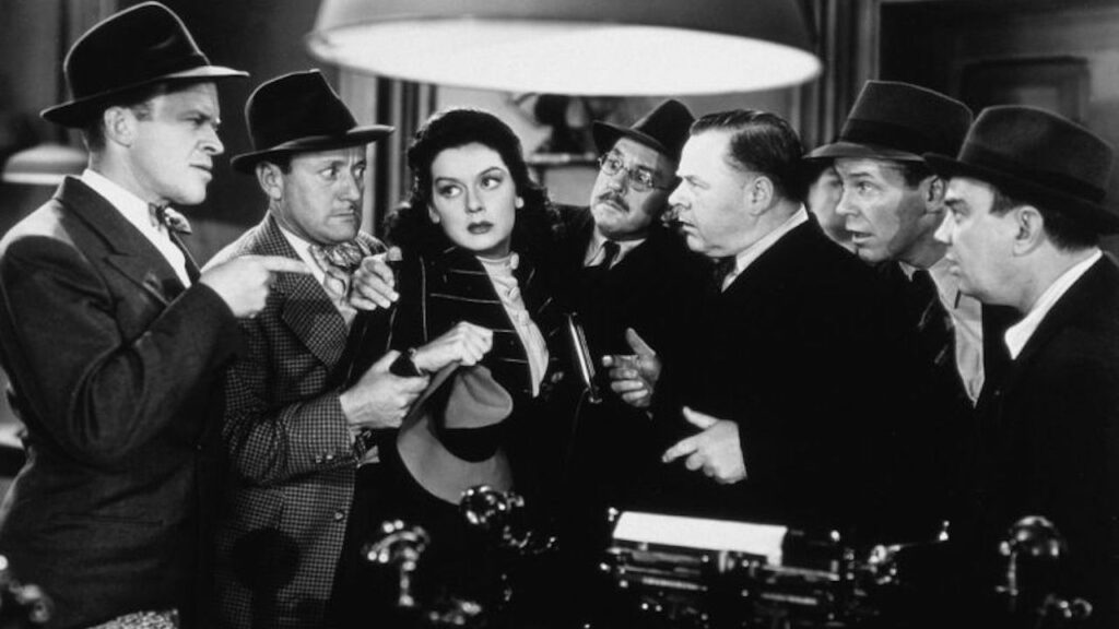 Hildy surrounded by male colleagues in His Girl Friday